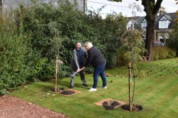 Photo of Rev Macrae and GB Leader Gillian planting tree